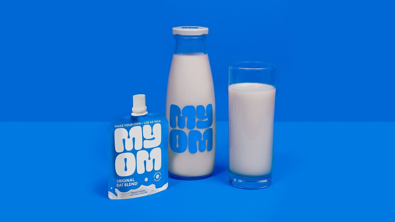 MYOM Oat Milk in a glass and glass bottle