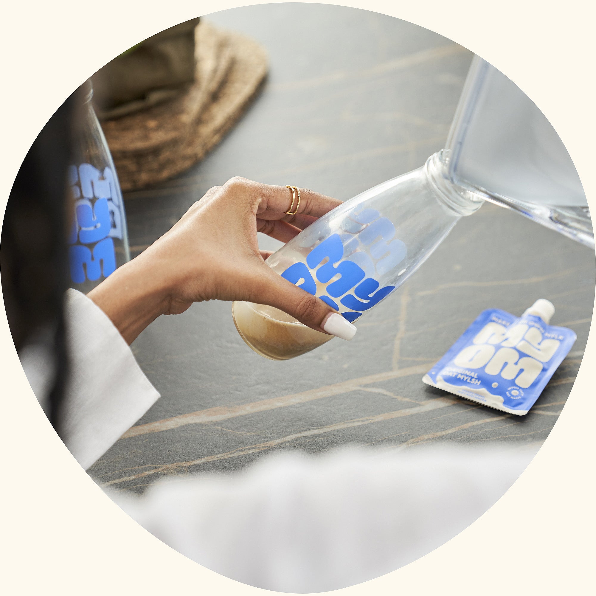 Photo of MYOM oat milk being poured into a bottle