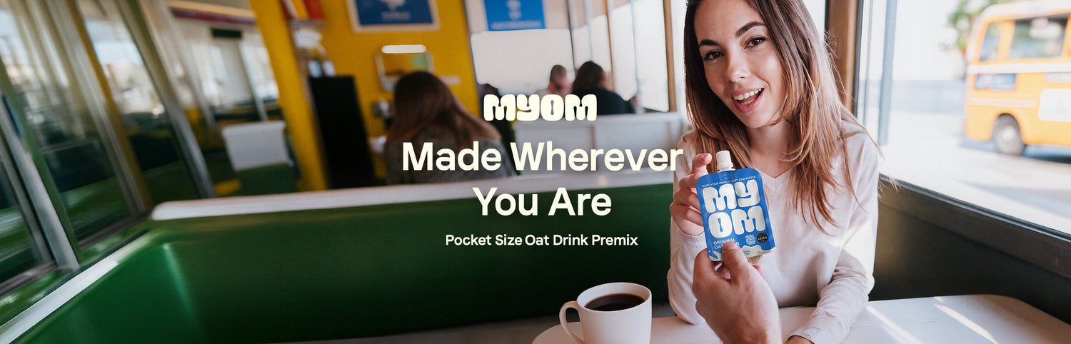 MYOM Original Oat Anywhere pouch handed across a café table