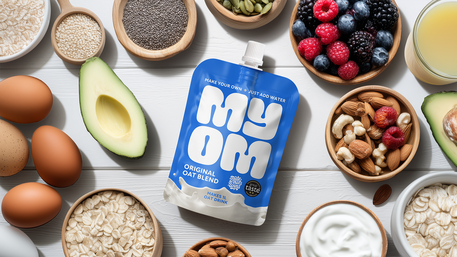 Selection of balanced breakfast foods including oats, eggs, nuts, yoghurt, fruit and oat milk, suitable for a GLP-1 diet.