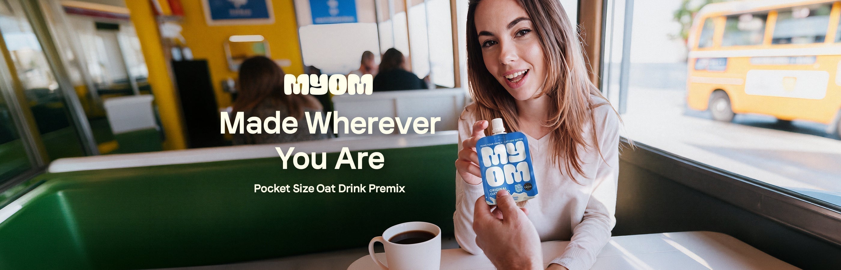 MYOM Original Oat Anywhere pouch handed across a café table