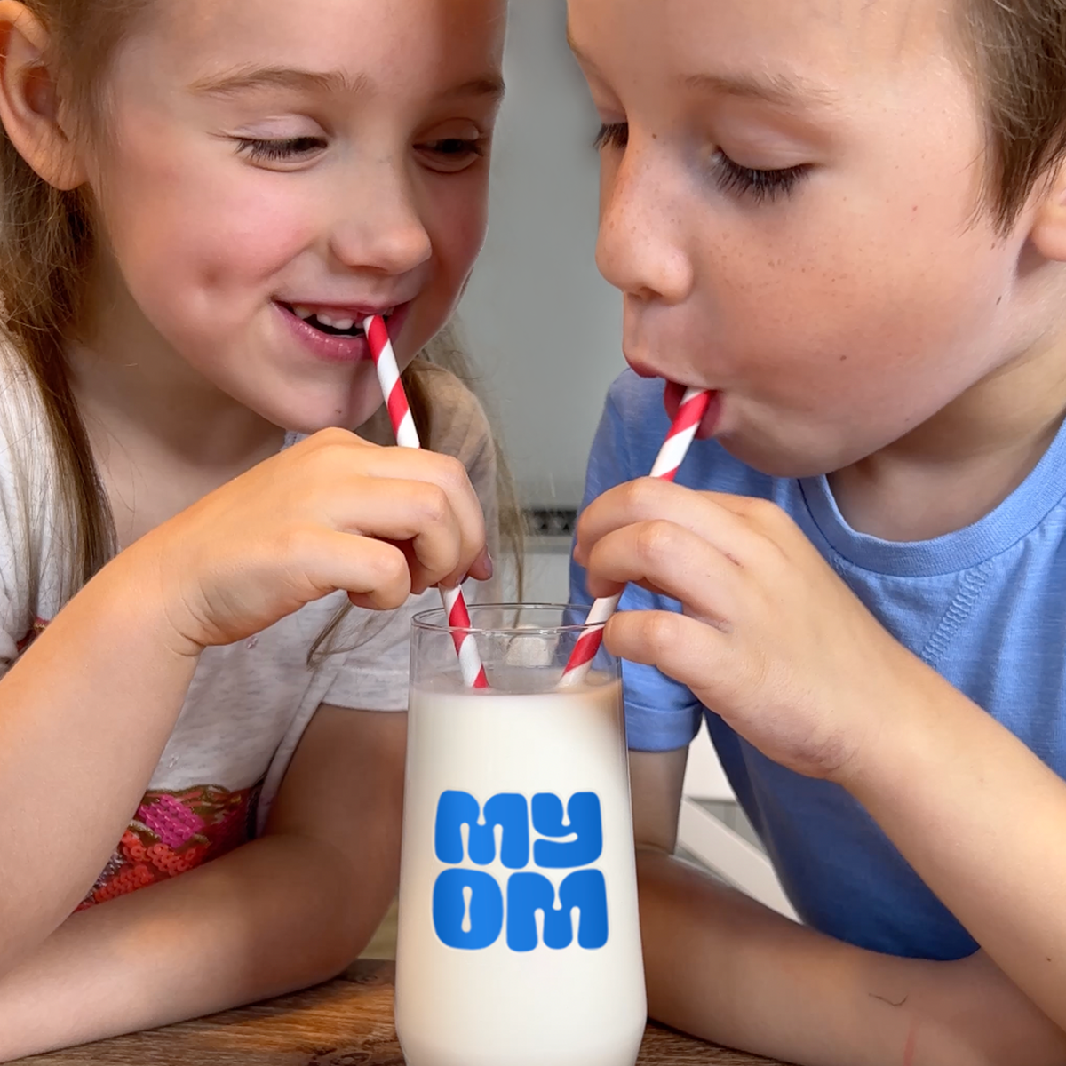 Photo of two people drinking MYOM milk 