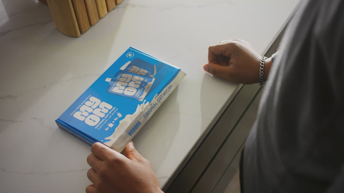 Pouring water into a MYOM bottle to make oat drink